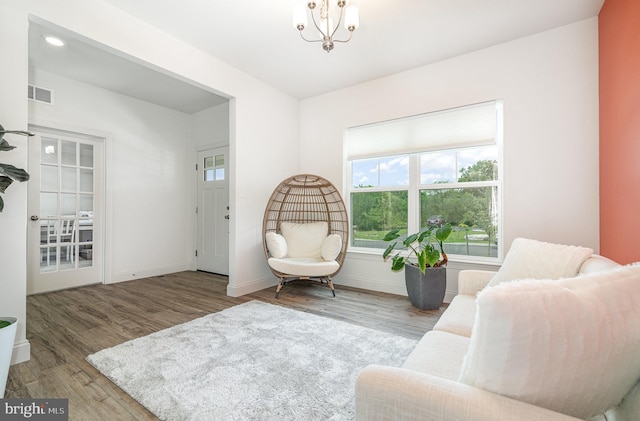 6320 Neha Dr, Mechanicsburg, PA 17050 - living area featuring wood finished floors, a chandelier, and baseboards