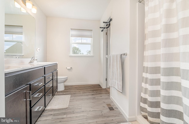 6320 Neha Dr, Mechanicsburg, PA 17050 - full bath with double vanity, wood finished floors, toilet, baseboards, and a shower with curtain