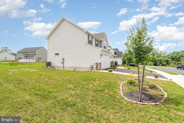 6320 Neha Dr, Mechanicsburg, PA 17050 - view of side of home featuring asphalt driveway, an attached garage, a lawn, and central air condition unit