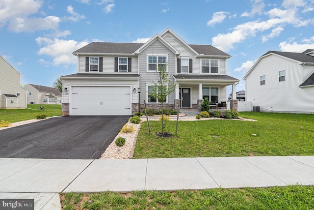 6320 Neha Dr, Mechanicsburg, PA 17050 - view of front of home featuring stone siding, a porch, asphalt driveway, an attached garage, and a front lawn