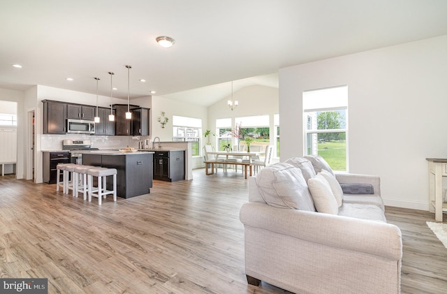 6320 Neha Dr, Mechanicsburg, PA 17050 - living area featuring a chandelier, light wood-type flooring, vaulted ceiling, recessed lighting, and baseboards