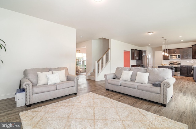 6320 Neha Dr, Mechanicsburg, PA 17050 - living room featuring light wood-style flooring, stairway, baseboards, and recessed lighting