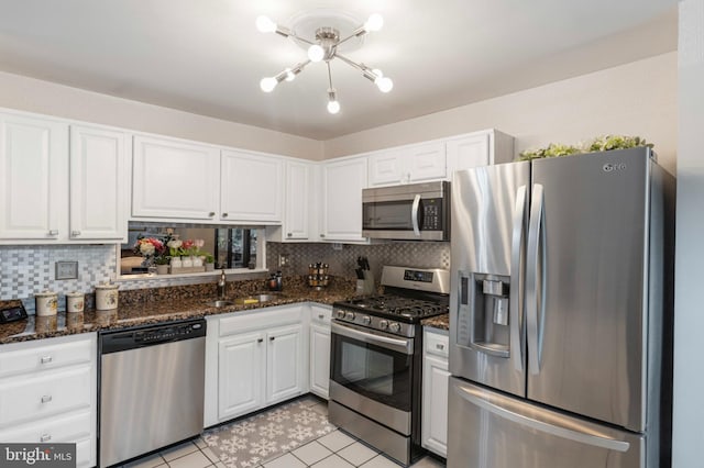 3214 Charing Cross Unit 18, Wilmington, DE 19808 - kitchen with stainless steel appliances, a sink, white cabinetry, and decorative backsplash