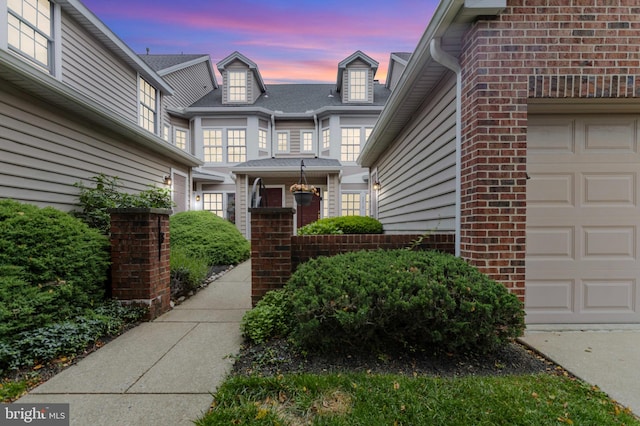 3214 Charing Cross Unit 18, Wilmington, DE 19808 - exterior entry at dusk featuring brick siding and an attached garage