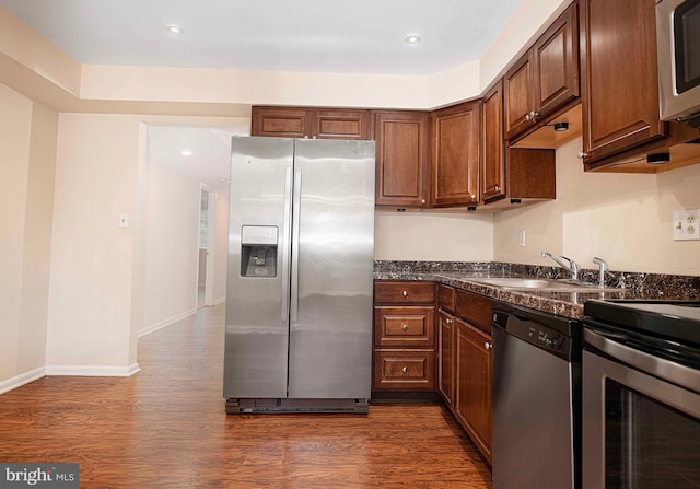 1 Lough Mask Ct Unit 101, Lutherville Timonium, MD 21093 - kitchen with stainless steel appliances, a sink, dark countertops, dark wood-style flooring, and recessed lighting