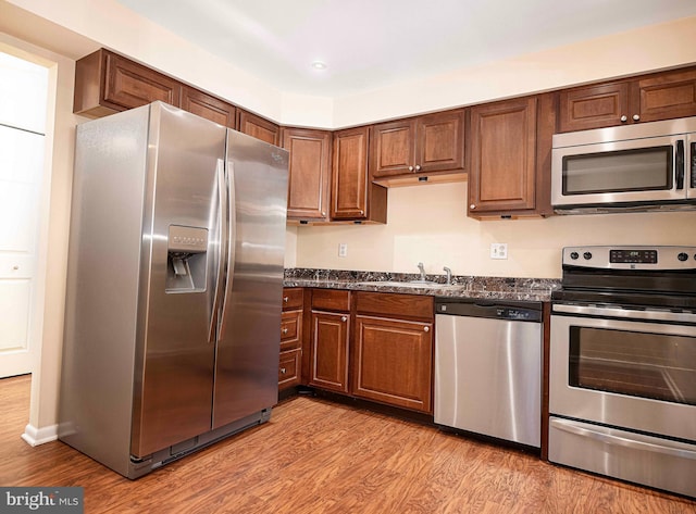 1 Lough Mask Ct Unit 101, Lutherville Timonium, MD 21093 - kitchen featuring appliances with stainless steel finishes, a sink, and light wood-style flooring