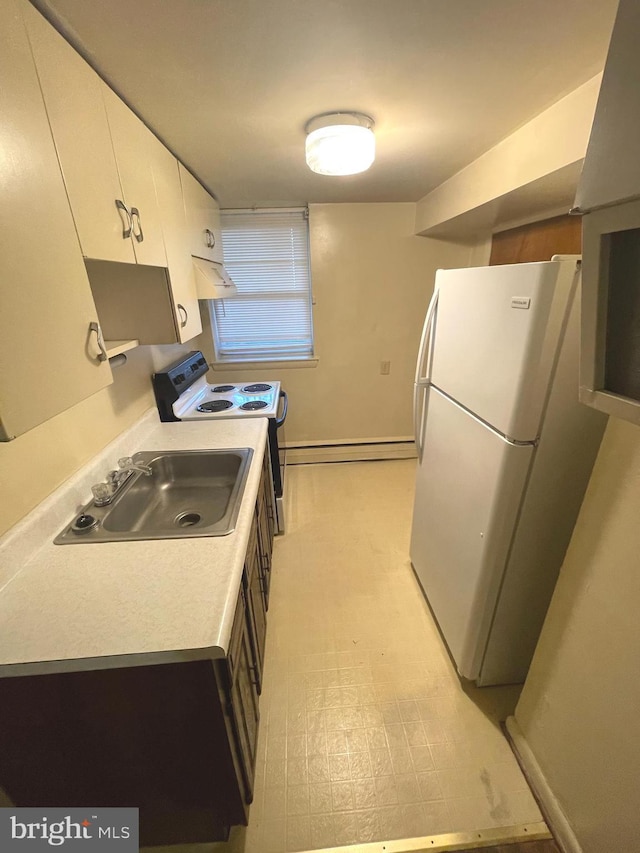 711 Oak Hill Ave, Hagerstown, MD 21740 - kitchen with freestanding refrigerator, under cabinet range hood, electric stove, a sink, and white cabinets