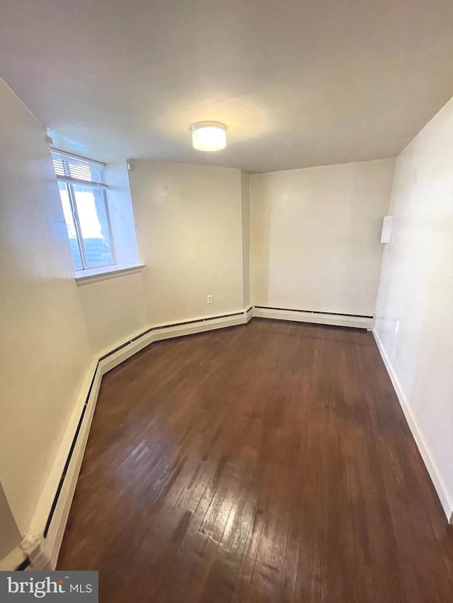 711 Oak Hill Ave, Hagerstown, MD 21740 - below grade area featuring dark wood finished floors and baseboards