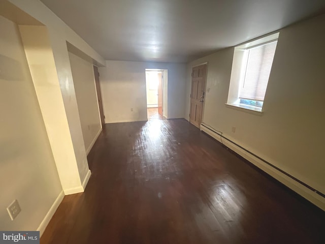 711 Oak Hill Ave, Hagerstown, MD 21740 - spare room with a baseboard heating unit, dark wood-style floors, and baseboards