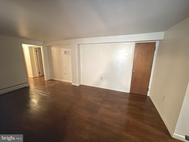 711 Oak Hill Ave, Hagerstown, MD 21740 - empty room featuring dark wood-type flooring, baseboards, and a baseboard radiator