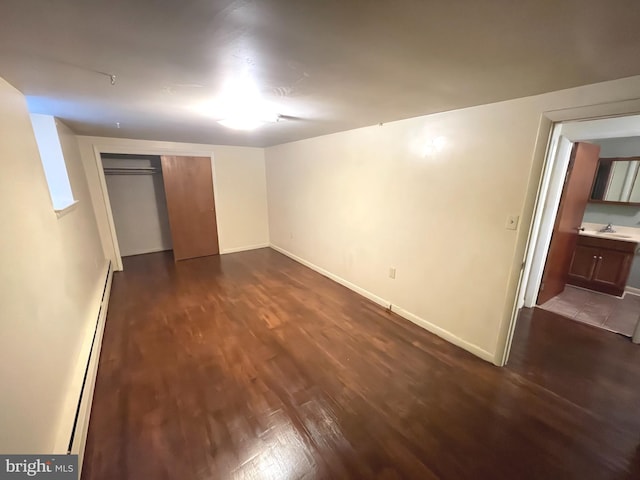 711 Oak Hill Ave, Hagerstown, MD 21740 - unfurnished bedroom with dark wood-type flooring, a baseboard radiator, baseboards, and a sink