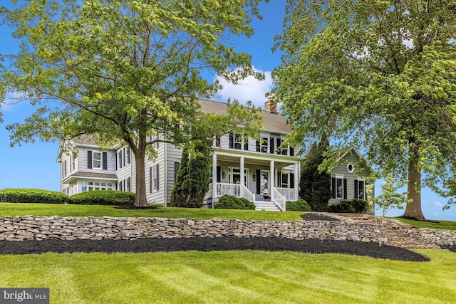 8423 Yellow Springs Rd, Frederick, MD 21702 - colonial home with a porch, a front yard, and a chimney