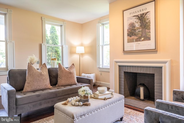 8423 Yellow Springs Rd, Frederick, MD 21702 - living room featuring healthy amount of natural light, a brick fireplace, wood finished floors, and baseboards