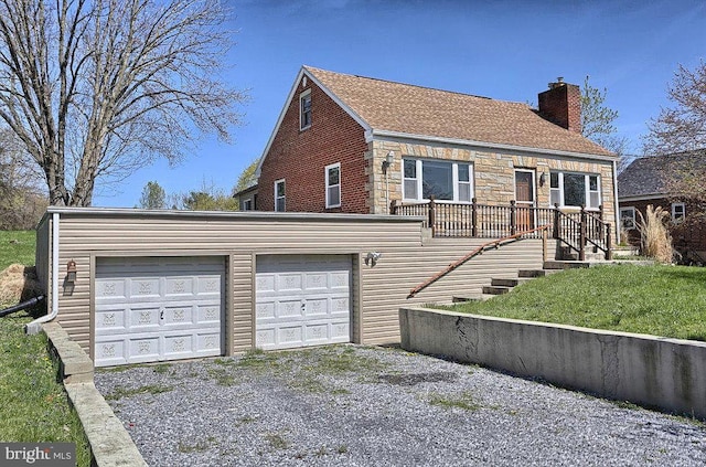 201 Village Rd, Harrisburg, PA 17112 - view of front of property featuring a chimney, driveway, a garage, stone siding, and stairs