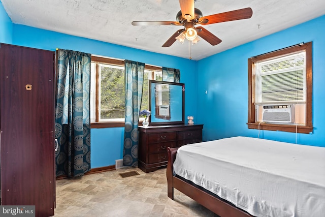 201 Village Rd, Harrisburg, PA 17112 - bedroom with baseboards, cooling unit, multiple windows, and stone finish floors