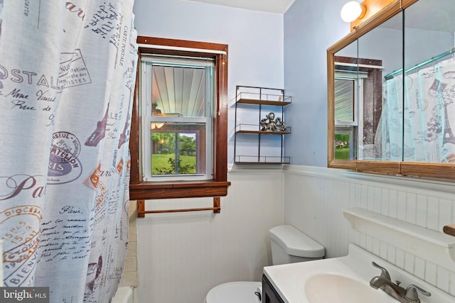 201 Village Rd, Harrisburg, PA 17112 - bathroom featuring toilet, a wainscoted wall, vanity, and shower / bath combination with curtain