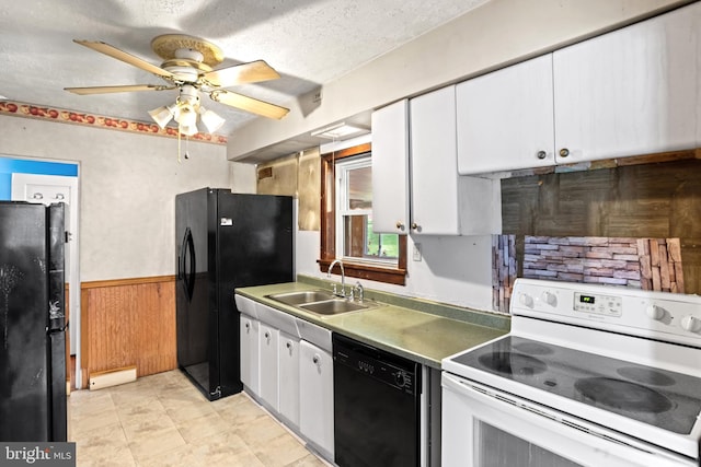 201 Village Rd, Harrisburg, PA 17112 - kitchen with black appliances, a sink, white cabinetry, a baseboard heating unit, and a wainscoted wall