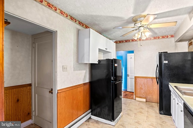 201 Village Rd, Harrisburg, PA 17112 - kitchen featuring freestanding refrigerator, wainscoting, ceiling fan, white cabinets, and dishwashing machine