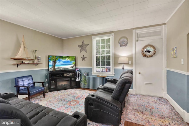 410 Windsor St, Wyomissing, PA 19610 - living area with wood finished floors, radiator, and crown molding