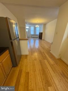 2012 E Glenwood Ave, Philadelphia, PA 19124 - hallway featuring a chandelier and light wood-style flooring