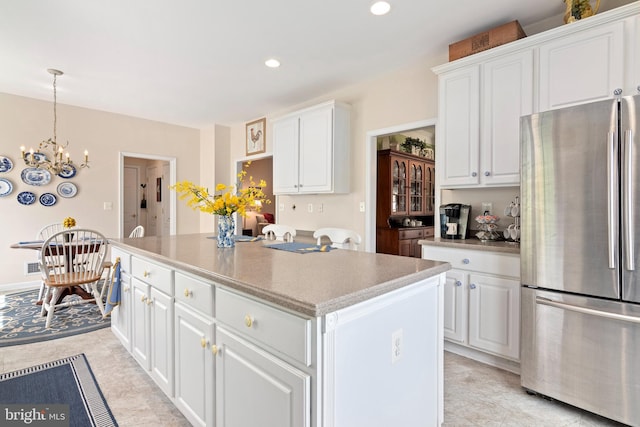 7482 Jeffreys Way, Easton, MD 21601 - kitchen with freestanding refrigerator, a kitchen island, white cabinets, a chandelier, and recessed lighting
