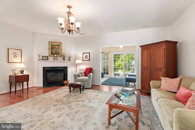 7482 Jeffreys Way, Easton, MD 21601 - living room featuring wood finished floors, a chandelier, and a fireplace with flush hearth