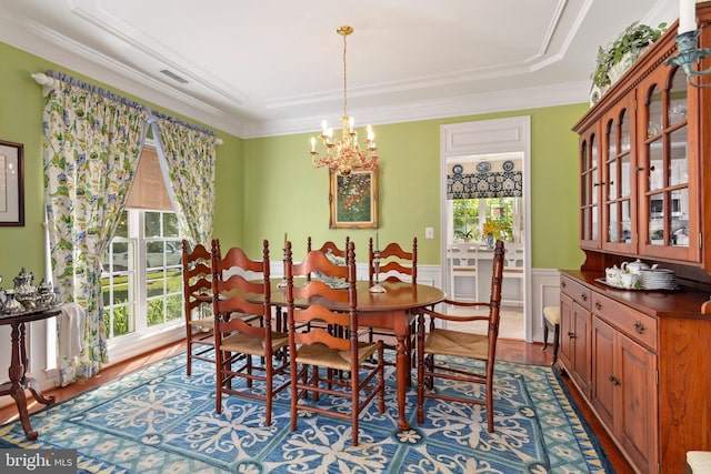 7482 Jeffreys Way, Easton, MD 21601 - dining area featuring healthy amount of natural light, a chandelier, crown molding, wood finished floors, and wainscoting
