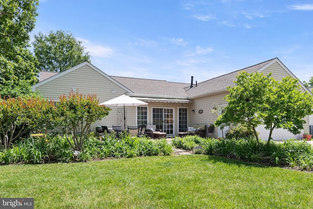 7482 Jeffreys Way, Easton, MD 21601 - back of house featuring a lawn, a shingled roof, and a patio
