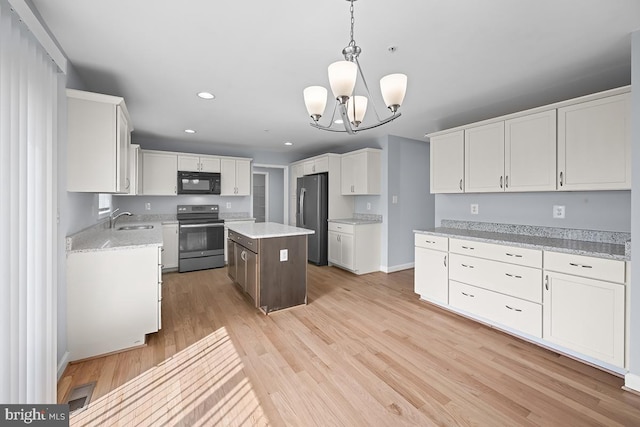 6712 Ridgecrest Rd, New Market, MD 21774 - kitchen featuring stainless steel appliances, a sink, white cabinets, light wood-style floors, and recessed lighting