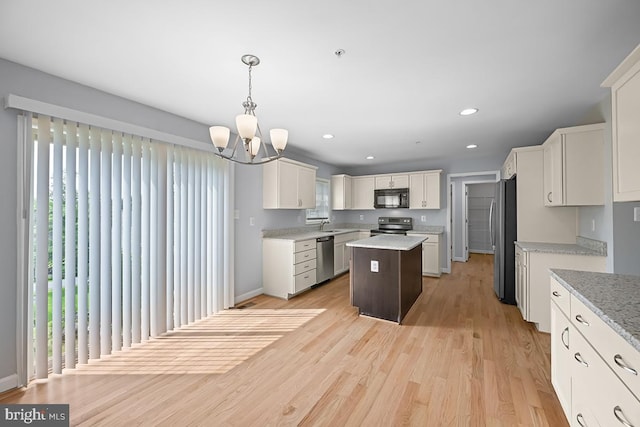 6712 Ridgecrest Rd, New Market, MD 21774 - kitchen with stainless steel appliances, a kitchen island, a chandelier, white cabinets, and light wood finished floors