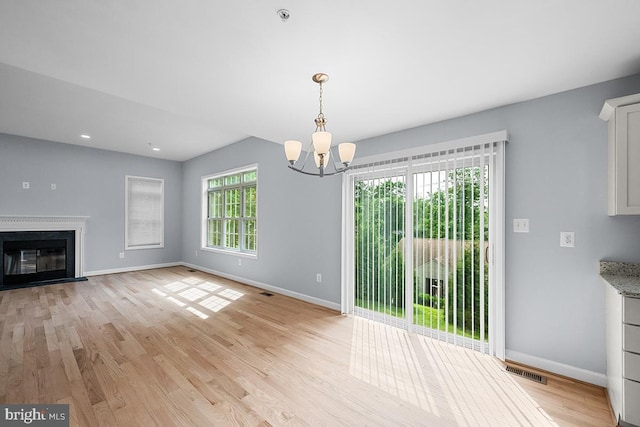 6712 Ridgecrest Rd, New Market, MD 21774 - unfurnished living room with a chandelier, baseboards, light wood-style flooring, a glass covered fireplace, and recessed lighting