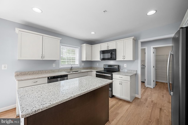 6712 Ridgecrest Rd, New Market, MD 21774 - kitchen with stainless steel appliances, light wood-style floors, white cabinetry, a center island, and recessed lighting