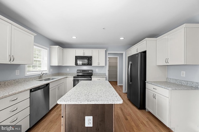6712 Ridgecrest Rd, New Market, MD 21774 - kitchen featuring black appliances, a sink, a kitchen island, white cabinets, and light wood-type flooring
