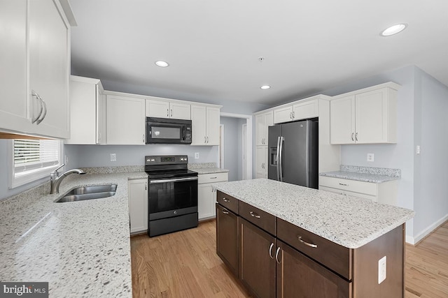6712 Ridgecrest Rd, New Market, MD 21774 - kitchen featuring black appliances, a sink, white cabinets, light wood-style floors, and recessed lighting