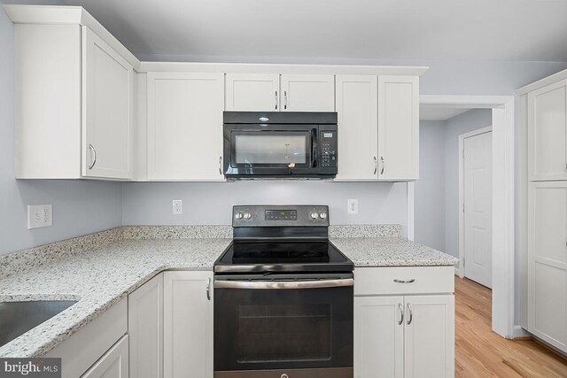 6712 Ridgecrest Rd, New Market, MD 21774 - kitchen with black microwave, stainless steel range with electric cooktop, white cabinets, light wood-type flooring, and light stone counters