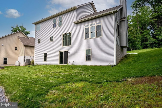 6712 Ridgecrest Rd, New Market, MD 21774 - back of house with a lawn, central AC unit, and a chimney