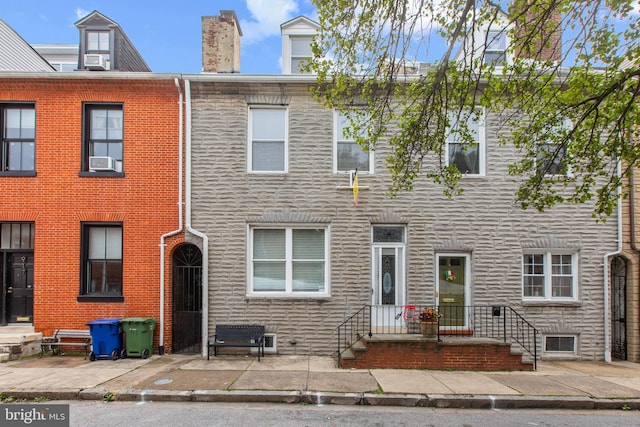 915 Stiles St, Baltimore, MD 21202 - multi unit property with stone siding, a chimney, and a patio area