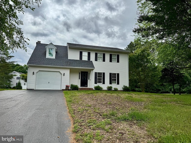 4001 Timothy Way, Salisbury, MD 21804 - view of front of home featuring an attached garage, asphalt driveway, a chimney, a shingled roof, and a front yard