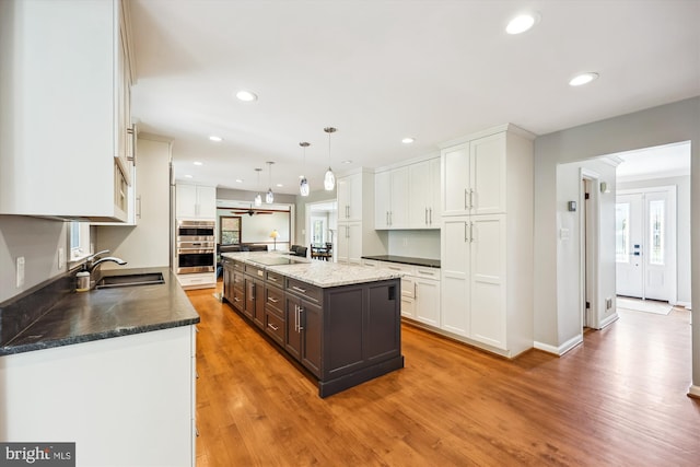 15221 Middlegate Rd, Silver Spring, MD 20905 - kitchen featuring white cabinetry, dark brown cabinets, a sink, healthy amount of natural light, and recessed lighting
