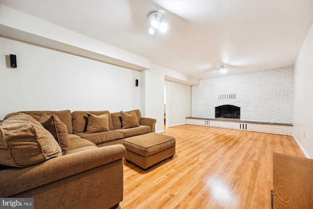 15221 Middlegate Rd, Silver Spring, MD 20905 - living room featuring a fireplace, light wood-type flooring, and baseboards