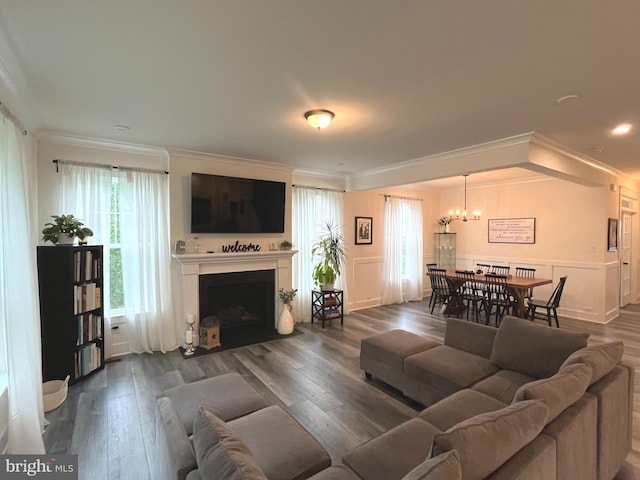 16801 Chalet Ct, Chesterfield, VA 23832 - living area with ornamental molding, a chandelier, dark wood-type flooring, and a fireplace with flush hearth