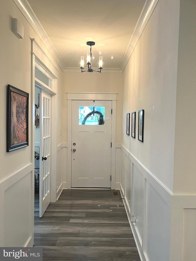 16801 Chalet Ct, Chesterfield, VA 23832 - entryway featuring a chandelier, dark wood-style floors, ornamental molding, a decorative wall, and a wainscoted wall
