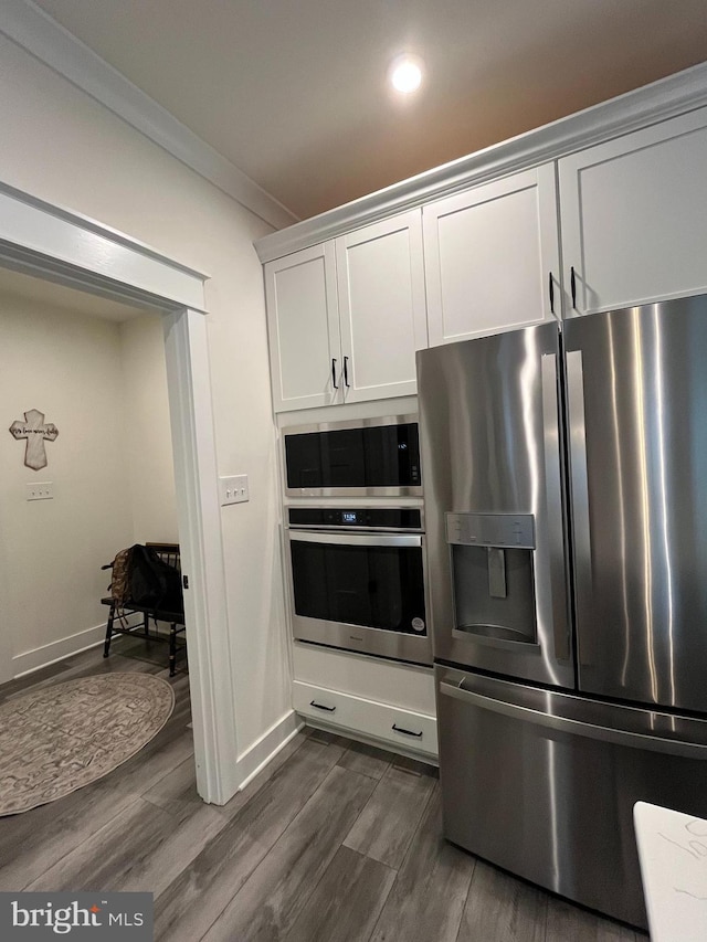 16801 Chalet Ct, Chesterfield, VA 23832 - kitchen featuring stainless steel appliances, dark wood-style floors, white cabinets, ornamental molding, and baseboards