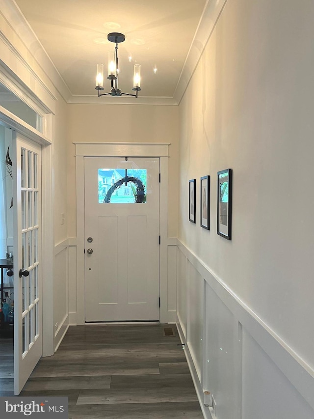 16801 Chalet Ct, Chesterfield, VA 23832 - doorway with ornamental molding, a chandelier, dark wood-type flooring, wainscoting, and a decorative wall
