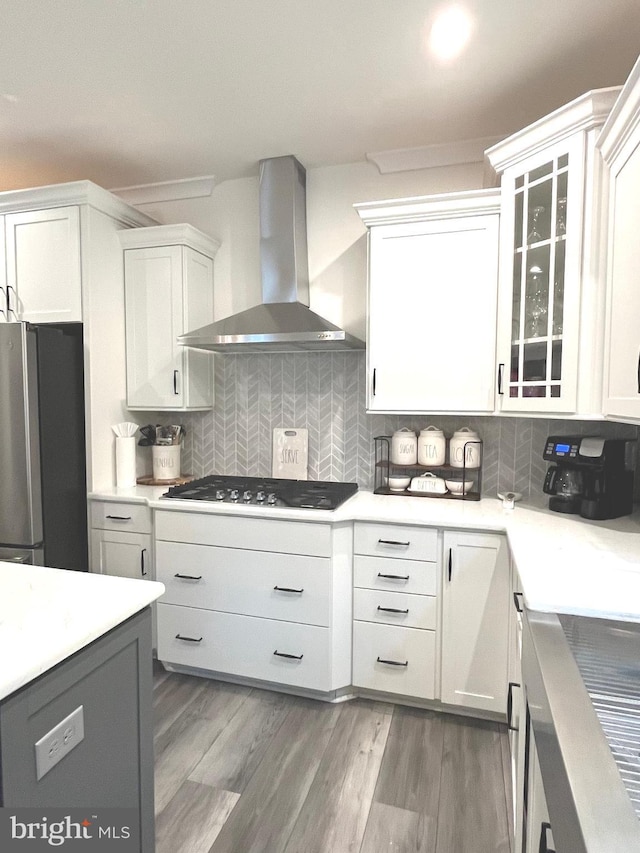 16801 Chalet Ct, Chesterfield, VA 23832 - kitchen featuring stainless steel appliances, wall chimney range hood, tasteful backsplash, and white cabinets
