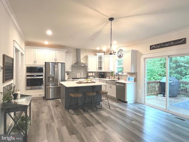 16801 Chalet Ct, Chesterfield, VA 23832 - kitchen with appliances with stainless steel finishes, wall chimney range hood, crown molding, decorative backsplash, and white cabinets