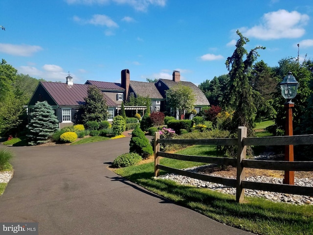1249 Pebble Hill Rd, Doylestown, PA 18901 - view of front of house featuring a standing seam roof, a chimney, and metal roof