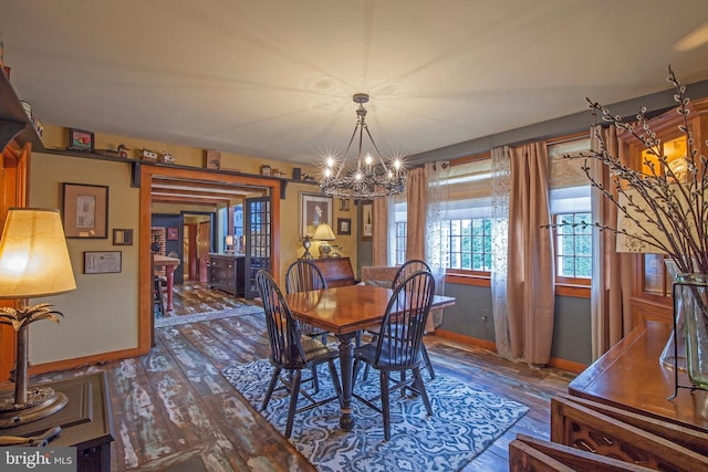 1249 Pebble Hill Rd, Doylestown, PA 18901 - dining area with wood finished floors, a chandelier, and baseboards