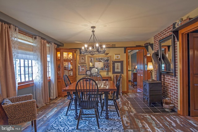 1249 Pebble Hill Rd, Doylestown, PA 18901 - dining space featuring wood finished floors, a chandelier, and a wood stove