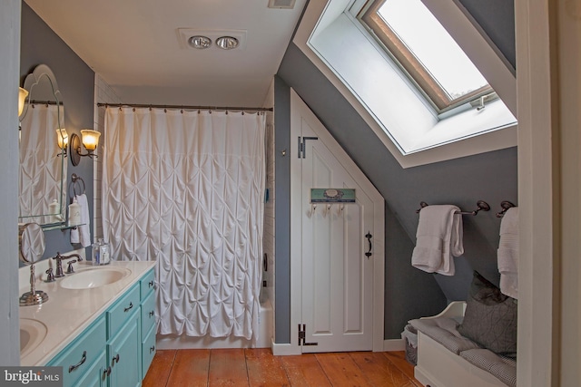 1249 Pebble Hill Rd, Doylestown, PA 18901 - full bathroom featuring a skylight, hardwood / wood-style flooring, double vanity, and shower / bath combination with curtain